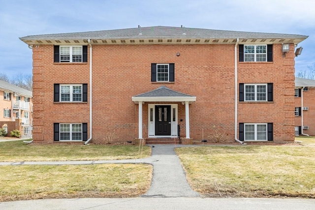 view of front of property with a front yard and brick siding