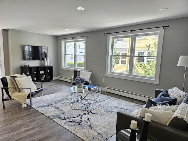 living room with wood-type flooring and baseboard heating