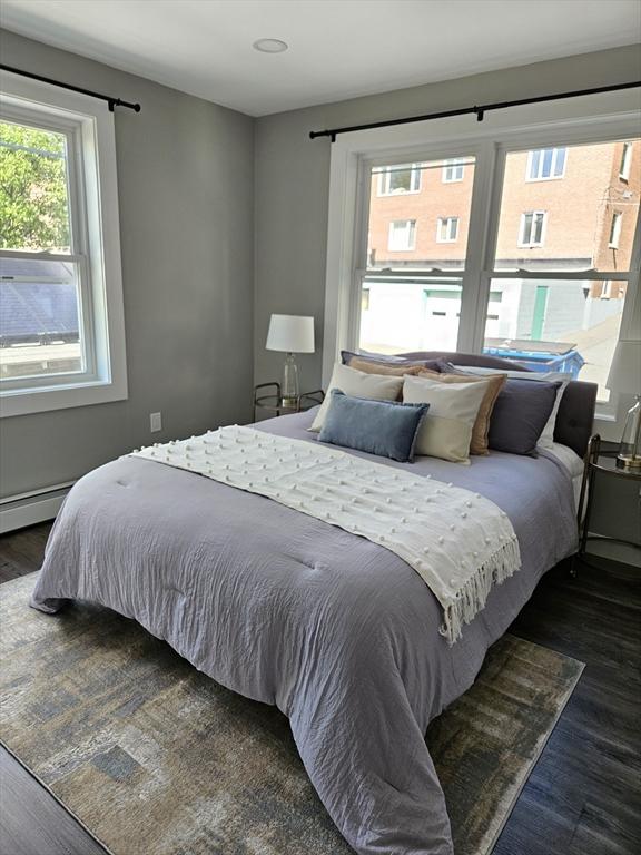 bedroom with dark wood-type flooring