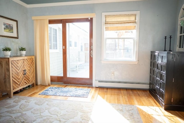 entryway with baseboard heating, crown molding, and wood finished floors