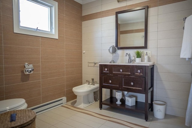 bathroom featuring tile walls, toilet, a bidet, vanity, and a baseboard radiator