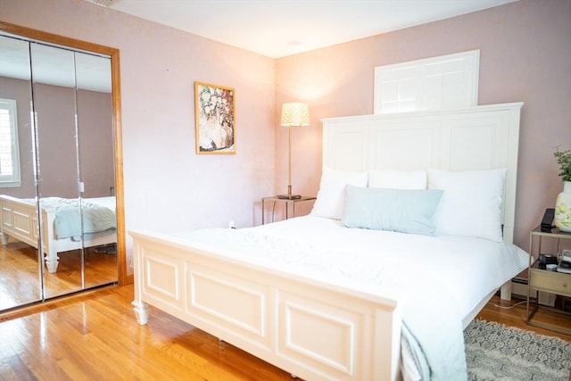 bedroom with a closet and light wood-type flooring