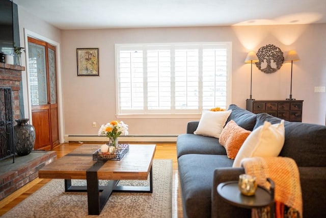 living area featuring baseboard heating, wood finished floors, and a fireplace