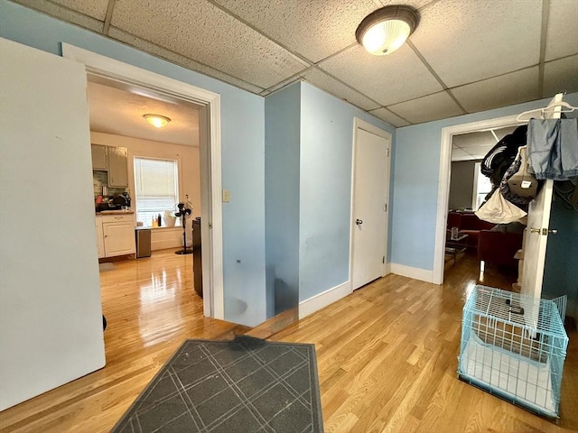 262 Adams St, Newton, MA 02458 - hall featuring a drop ceiling, light wood finished floors, and baseboards