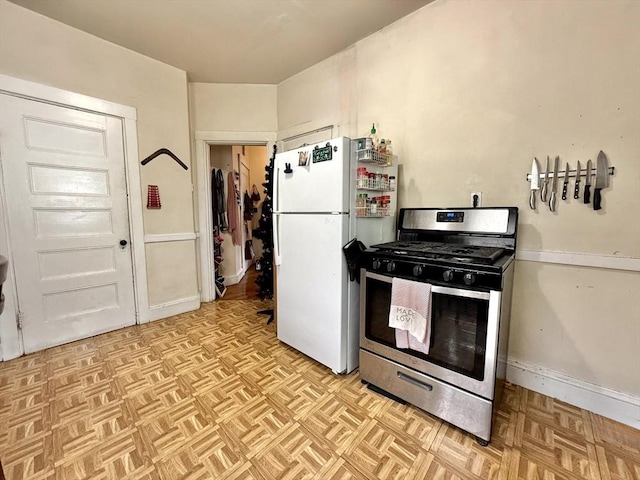 262 Adams St, Newton, MA 02458 - kitchen with stainless steel gas range and freestanding refrigerator