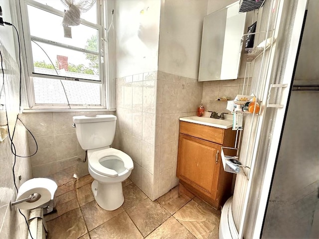 262 Adams St, Newton, MA 02458 - bathroom featuring tile walls, vanity, toilet, and wainscoting