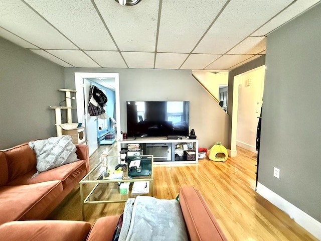 262 Adams St, Newton, MA 02458 - living area with a paneled ceiling, wood finished floors, and baseboards