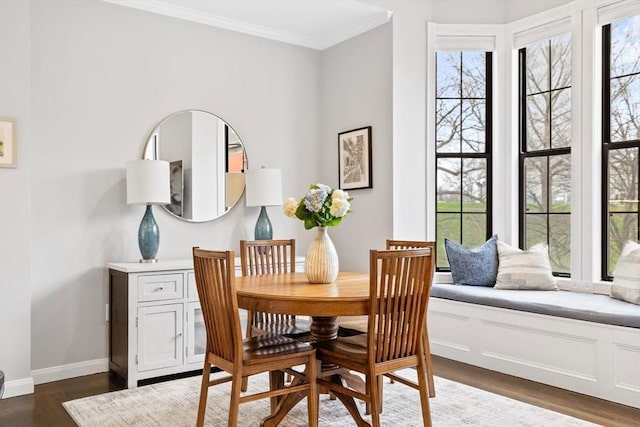 dining area featuring crown molding, baseboards, plenty of natural light, and dark wood-style floors