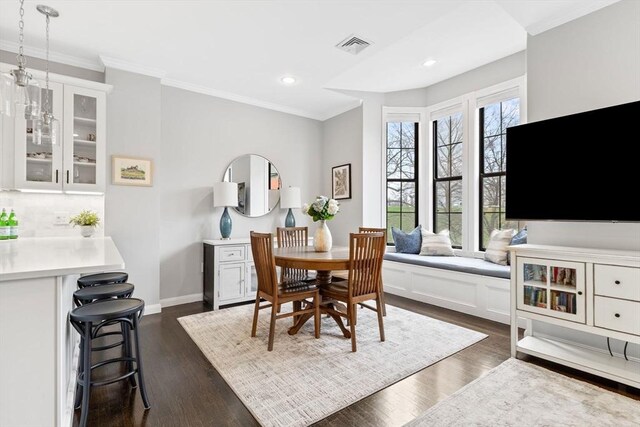 dining space featuring crown molding, recessed lighting, baseboards, and dark wood-type flooring