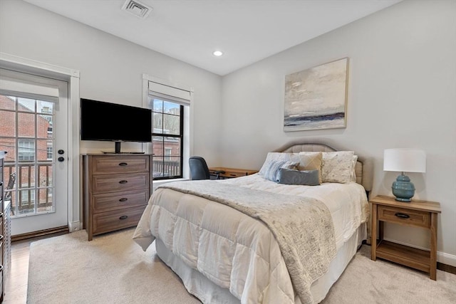 bedroom with visible vents, baseboards, multiple windows, and access to exterior