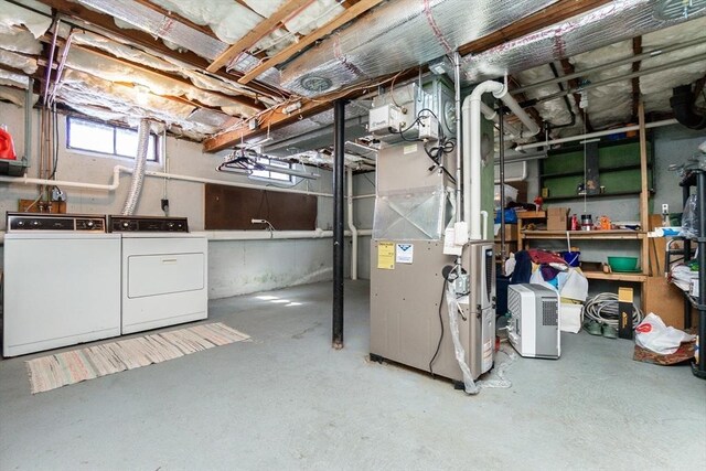 below grade area with washing machine and clothes dryer and heating unit