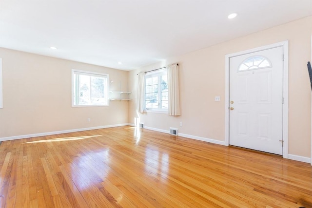 foyer featuring baseboards, recessed lighting, visible vents, and light wood-style floors