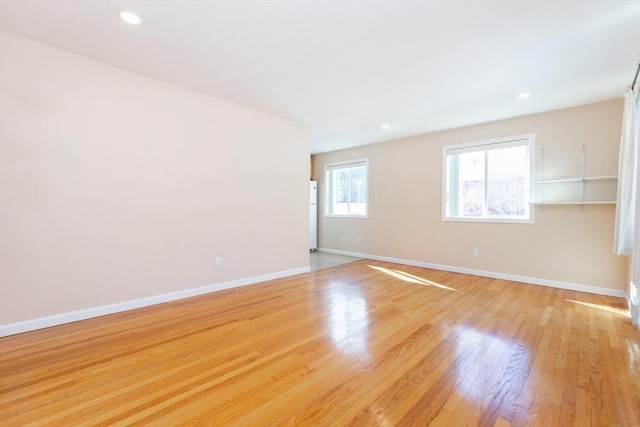 unfurnished room featuring light wood-style floors, recessed lighting, and baseboards