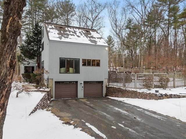 view of snowy exterior with a garage