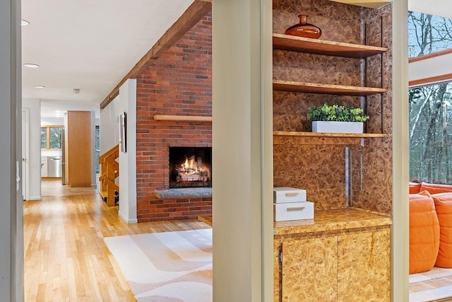 hallway featuring light wood-type flooring and a wealth of natural light