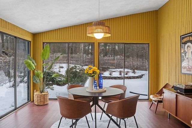 sunroom / solarium featuring vaulted ceiling