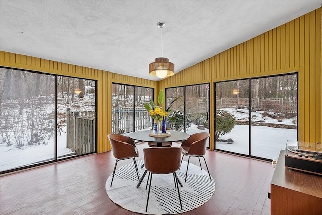 sunroom / solarium featuring vaulted ceiling