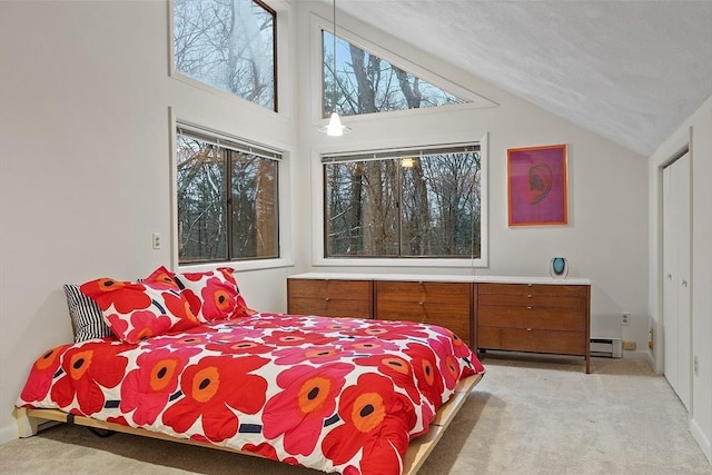 carpeted bedroom with baseboard heating and vaulted ceiling