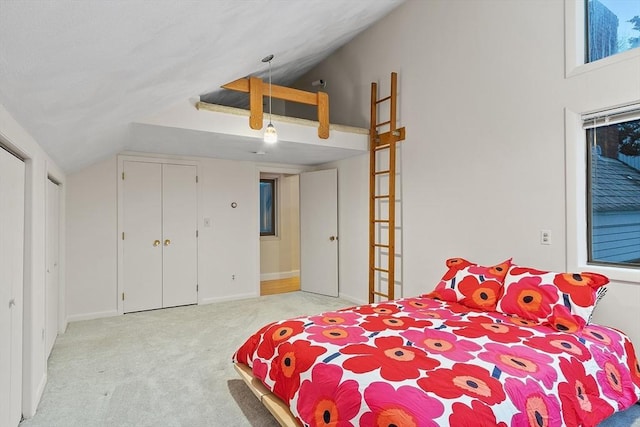 bedroom with light colored carpet and lofted ceiling