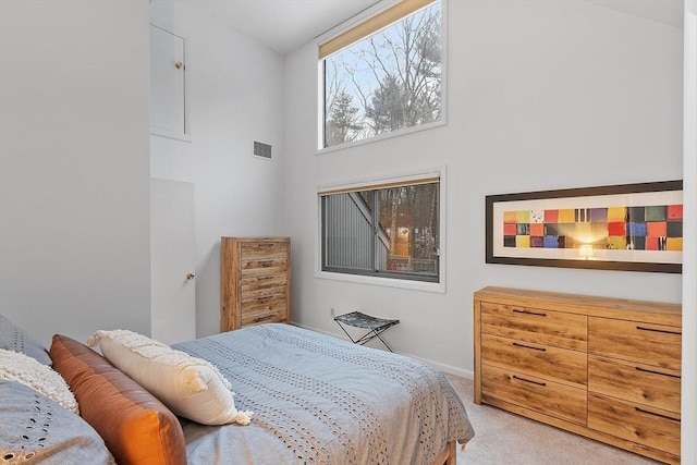 carpeted bedroom featuring a high ceiling