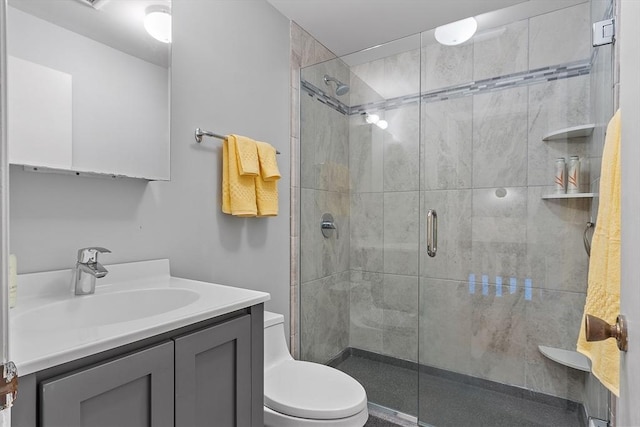 bathroom with vanity, toilet, and a shower with door