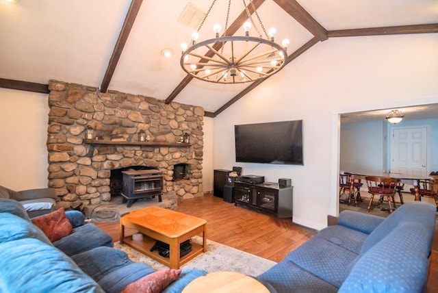 95 N Lowell St, Methuen, MA 01844 - living room featuring a chandelier, beamed ceiling, wood finished floors, a wood stove, and high vaulted ceiling