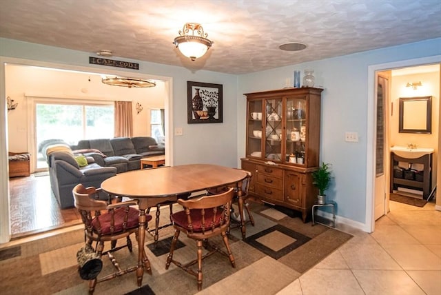 95 N Lowell St, Methuen, MA 01844 - dining area with light tile patterned flooring and a textured ceiling