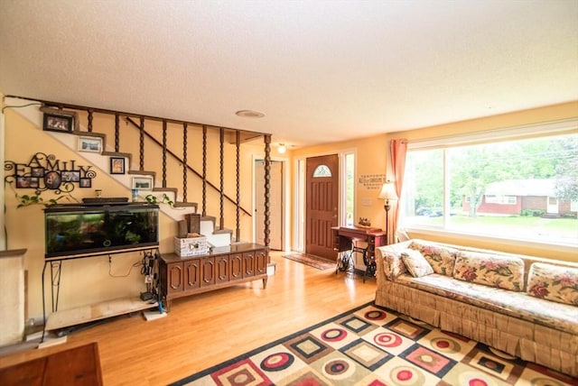 95 N Lowell St, Methuen, MA 01844 - living room with wood finished floors, stairway, and plenty of natural light