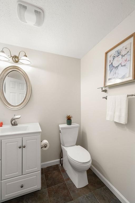 20 Hawthorne Vlg Unit C, Franklin, MA 02038 - half bathroom with vanity and a textured ceiling