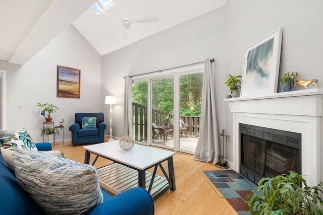 20 Hawthorne Vlg Unit C, Franklin, MA 02038 - living room featuring a fireplace with flush hearth, light wood-style flooring, ceiling fan, and vaulted ceiling