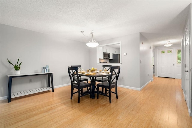 20 Hawthorne Vlg Unit C, Franklin, MA 02038 - dining room featuring light wood-type flooring and a textured ceiling