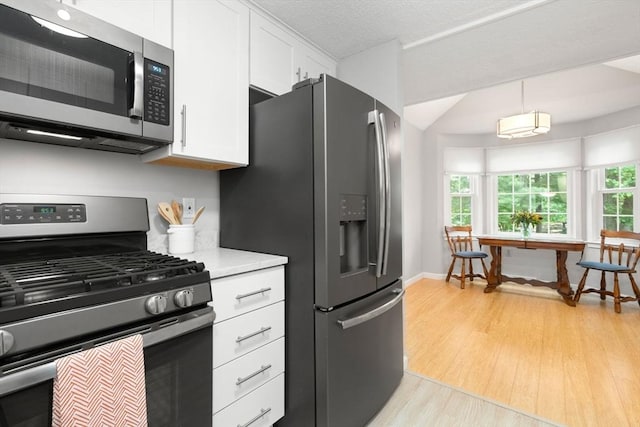 20 Hawthorne Vlg Unit C, Franklin, MA 02038 - kitchen with appliances with stainless steel finishes, white cabinetry, light wood-style floors, and light countertops