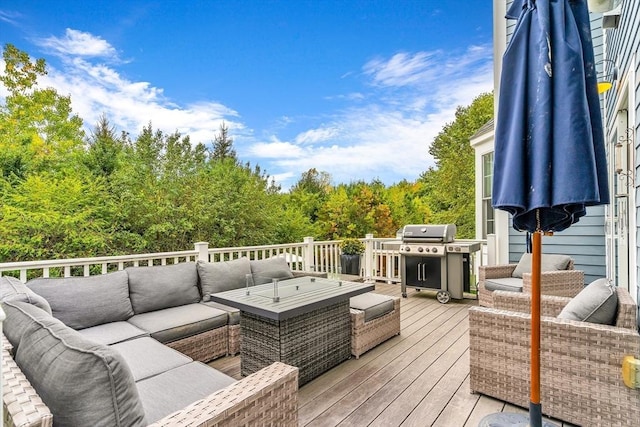 deck with outdoor lounge area and a grill