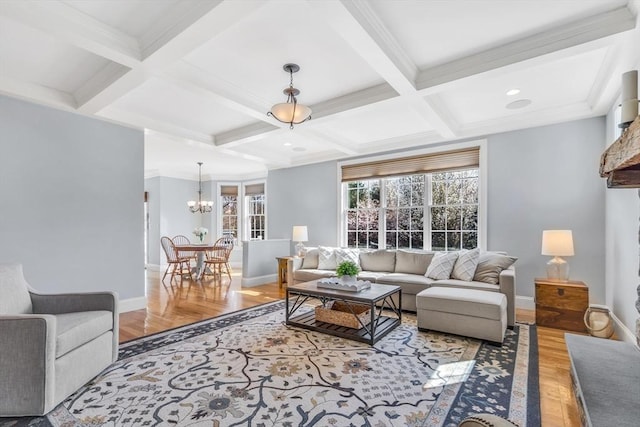 living area featuring beam ceiling, wood finished floors, baseboards, a chandelier, and coffered ceiling