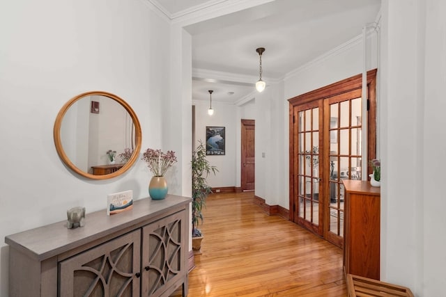 hallway with crown molding, light hardwood / wood-style flooring, and french doors