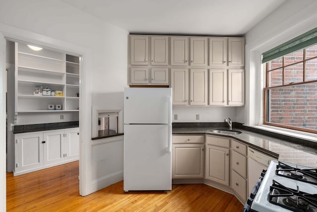 kitchen featuring gray cabinets, light hardwood / wood-style flooring, sink, and white appliances