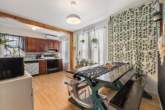 kitchen featuring stainless steel dishwasher, electric range, backsplash, and light hardwood / wood-style flooring