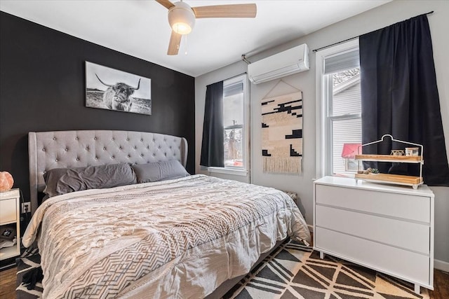 bedroom with ceiling fan and a wall mounted air conditioner