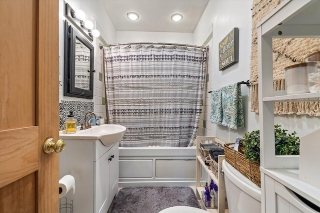 full bathroom featuring vanity, toilet, shower / tub combo, and decorative backsplash