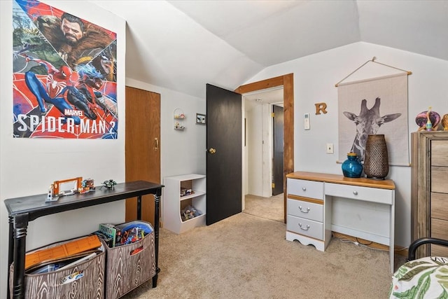 bedroom with lofted ceiling and light carpet