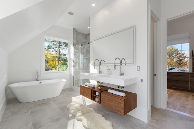 bathroom with separate shower and tub, sink, and plenty of natural light