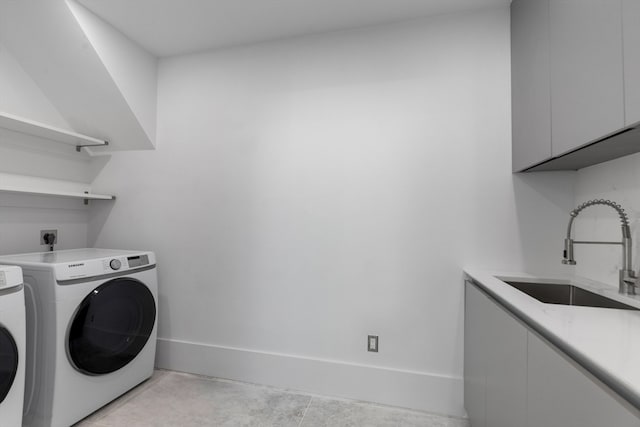 washroom with light tile patterned flooring, cabinets, sink, and separate washer and dryer