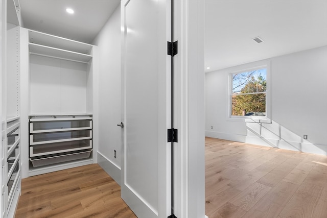 walk in closet featuring light hardwood / wood-style flooring