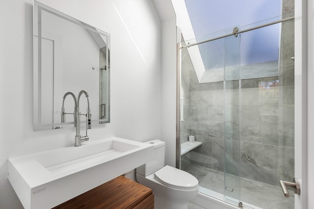 bathroom with vanity, toilet, and a shower with shower door