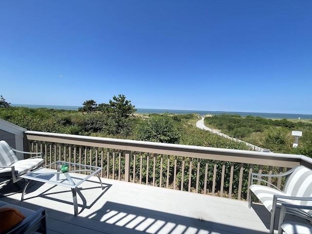 wooden terrace featuring a water view