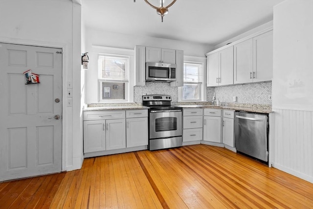 kitchen featuring light hardwood / wood-style flooring, plenty of natural light, and appliances with stainless steel finishes