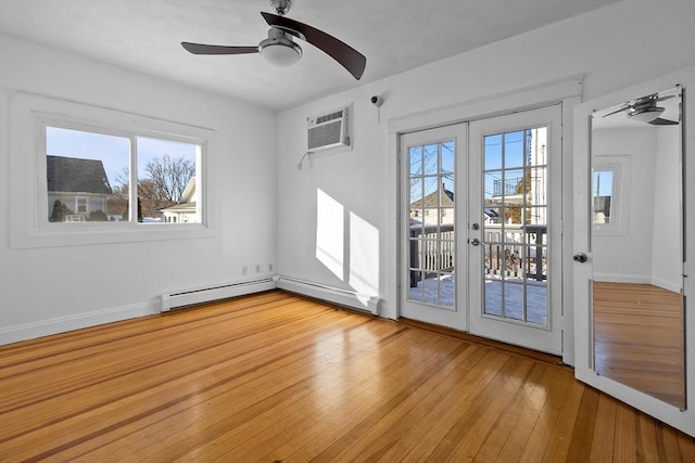 interior space with an AC wall unit, a healthy amount of sunlight, ceiling fan, and french doors