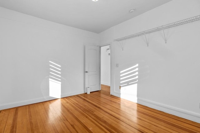 empty room with hardwood / wood-style flooring