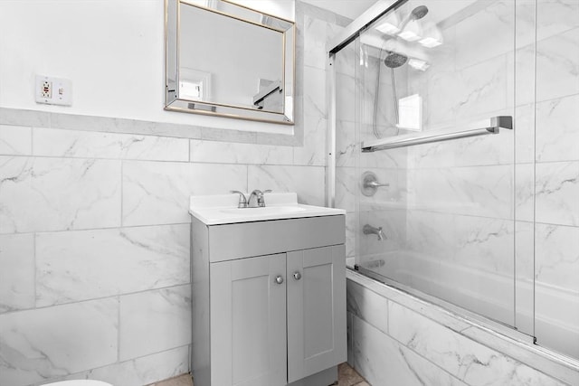 bathroom with vanity and combined bath / shower with glass door