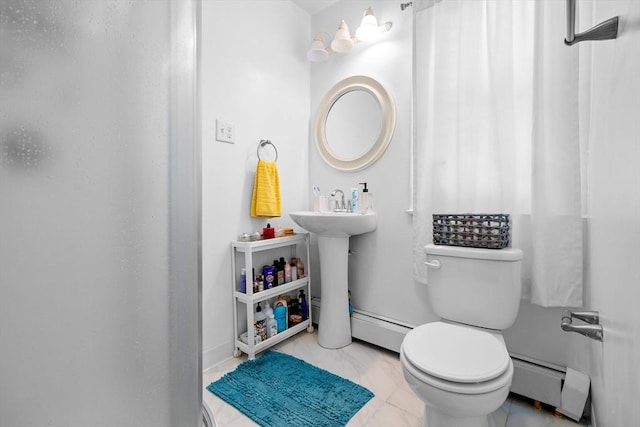 bathroom with a baseboard heating unit and toilet